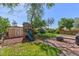 Charming backyard with a wooden deck, fire pit, playground, and a storage shed, ideal for Gathering gatherings at 11320 Irma Dr, Northglenn, CO 80233