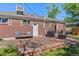 A view of the backyard with a deck, seating, grill, firepit, and grass for outdoor enjoyment at 11320 Irma Dr, Northglenn, CO 80233