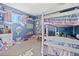Charming bedroom with blue walls, bunk beds, a window, and play area filled with toys and books at 11320 Irma Dr, Northglenn, CO 80233