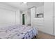 Spacious bedroom featuring ample closet space, plush carpeting, and a comfortable bed with floral patterned bedding at 11320 Irma Dr, Northglenn, CO 80233
