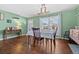 A well-lit dining space with a table, hardwood floors, and a view out the window at 11320 Irma Dr, Northglenn, CO 80233
