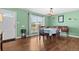Bright dining room with hardwood floors, a classic table, and a large window at 11320 Irma Dr, Northglenn, CO 80233