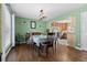 Cozy dining room featuring hardwood floors, a vintage table set, and ample natural light at 11320 Irma Dr, Northglenn, CO 80233