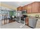 View of kitchen with stainless steel appliances next to dining room at 11320 Irma Dr, Northglenn, CO 80233