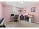 Bright home office with pink walls, desk, and a piano at 11320 Irma Dr, Northglenn, CO 80233