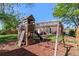 Backyard with a playground structure including swings, slide, and climbing wall, providing fun activities for children at 11320 Irma Dr, Northglenn, CO 80233