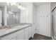 Bathroom with double sink vanity, granite countertop, and glass-enclosed shower at 4028 N Rome St, Aurora, CO 80019