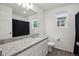 Bathroom featuring a granite countertop, vanity and shower/tub combination at 4028 N Rome St, Aurora, CO 80019