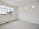 Bright bedroom featuring a large window and neutral carpeting at 4028 N Rome St, Aurora, CO 80019