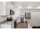 Contemporary kitchen featuring stainless appliances, granite counters, and white cabinets at 4028 N Rome St, Aurora, CO 80019