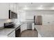 Modern kitchen with stainless steel appliances, granite countertops, and white cabinets at 4028 N Rome St, Aurora, CO 80019