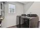 Modern laundry room with a front-load washer and dryer at 4028 N Rome St, Aurora, CO 80019