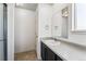 Well-lit bathroom features a vanity with dark cabinets and a separate shower area at 13095 W Cedar Dr # 302, Lakewood, CO 80228