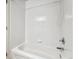 Bathroom featuring a soaking tub with white tile surround at 13095 W Cedar Dr # 302, Lakewood, CO 80228