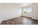 Clean bedroom with wood flooring, a large window for natural light, and white walls at 13095 W Cedar Dr # 302, Lakewood, CO 80228