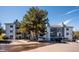 Apartment building with visible balconies and mature trees offering shade and curb appeal at 13095 W Cedar Dr # 302, Lakewood, CO 80228