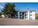 Apartment building exterior showcasing parking, landscaping and private balconies at 13095 W Cedar Dr # 302, Lakewood, CO 80228