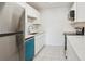 Modern kitchen features stainless steel appliances, white cabinets, and a tiled backsplash at 13095 W Cedar Dr # 302, Lakewood, CO 80228