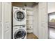 Convenient laundry closet with stacked washer/dryer and shelving at 13095 W Cedar Dr # 302, Lakewood, CO 80228