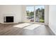 Living room with fireplace and sliding glass doors opening to the balcony at 13095 W Cedar Dr # 302, Lakewood, CO 80228