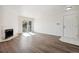 Living room featuring a fireplace, balcony door, and entry door at 13095 W Cedar Dr # 302, Lakewood, CO 80228
