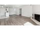 Spacious living room with fireplace, hardwood floors, and open concept to kitchen at 13095 W Cedar Dr # 302, Lakewood, CO 80228