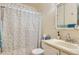 Functional bathroom with a shower-tub combo, leaf-patterned curtain, and a classic vanity with a mirrored medicine cabinet at 2108 S Idalia S St, Aurora, CO 80013
