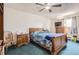 Comfortable bedroom with a wooden sleigh bed, matching nightstands, and a ceiling fan for added comfort at 2108 S Idalia S St, Aurora, CO 80013