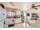 Bright kitchen with white cabinets, a ceiling fan, and a dining area, perfect for casual meals and entertaining at 2108 S Idalia S St, Aurora, CO 80013