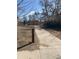 Neighborhood sidewalk going past a wooded lot with trees and ground cover at 2108 S Idalia S St, Aurora, CO 80013
