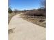 Concrete walking path surrounded by native landscaping providing easy access for recreation and leisure at 2108 S Idalia S St, Aurora, CO 80013