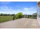 Expansive deck with black railing showcases views of the lush backyard and surrounding landscape at 7226 Dove Ct, Parker, CO 80134