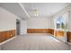 Spacious basement with a ceiling fan, neutral carpet, and wood-paneled walls at 7226 Dove Ct, Parker, CO 80134