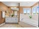 The bathroom has a double vanity, a soaking tub, and a window with outdoor views at 7226 Dove Ct, Parker, CO 80134