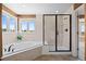 The bathroom has a soaking tub and a glass shower with tile surround, plus a window with outdoor views at 7226 Dove Ct, Parker, CO 80134