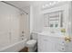 Well-lit bathroom featuring a shower-tub combo, white vanity, and hardwood-style flooring at 7226 Dove Ct, Parker, CO 80134
