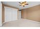 Bedroom with a ceiling fan, standard closet, neutral carpet, and an ensuite bathroom at 7226 Dove Ct, Parker, CO 80134