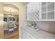 Butler's pantry with glass-front cabinets and granite countertops at 7226 Dove Ct, Parker, CO 80134
