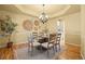 Elegant dining room with modern chandelier and seating for six at 7226 Dove Ct, Parker, CO 80134