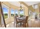 Bright dining area surrounded by large windows offering picturesque views and a stylish chandelier at 7226 Dove Ct, Parker, CO 80134