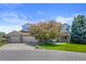 Charming brick home with well-manicured lawn, mature trees, and three-car garage at 7226 Dove Ct, Parker, CO 80134