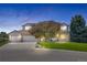 Charming brick home with well-manicured lawn, mature trees, and three-car garage at 7226 Dove Ct, Parker, CO 80134