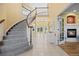 Grand foyer with curved staircase, tiled floors, and natural light at 7226 Dove Ct, Parker, CO 80134
