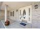 Inviting front porch with elegant door, sidelights, and brick accents at 7226 Dove Ct, Parker, CO 80134