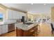 Open concept kitchen with a large island, stainless steel appliances and seamless flow to the living room at 7226 Dove Ct, Parker, CO 80134