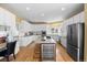 Bright kitchen features white cabinetry, granite countertops, stainless steel appliances, and a center island with a wine fridge at 7226 Dove Ct, Parker, CO 80134