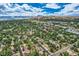 Panoramic aerial view of a neighborhood with mature trees and homes, set against a mountain backdrop at 12176 W Ohio Pl, Lakewood, CO 80228