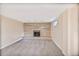 Spacious carpeted basement featuring a decorative fireplace with stone surround and ample natural light at 12176 W Ohio Pl, Lakewood, CO 80228