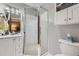 Bathroom featuring a glass shower, modern vanity with black and white backsplash, and stylish fixtures at 12176 W Ohio Pl, Lakewood, CO 80228