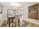 Elegant dining room with hardwood floors, a chandelier, and a built-in cabinet at 12176 W Ohio Pl, Lakewood, CO 80228